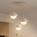 BRILAGI - Pakaramā lustra uz troses COSMO 3xE27/60W/230V bēša/zelta