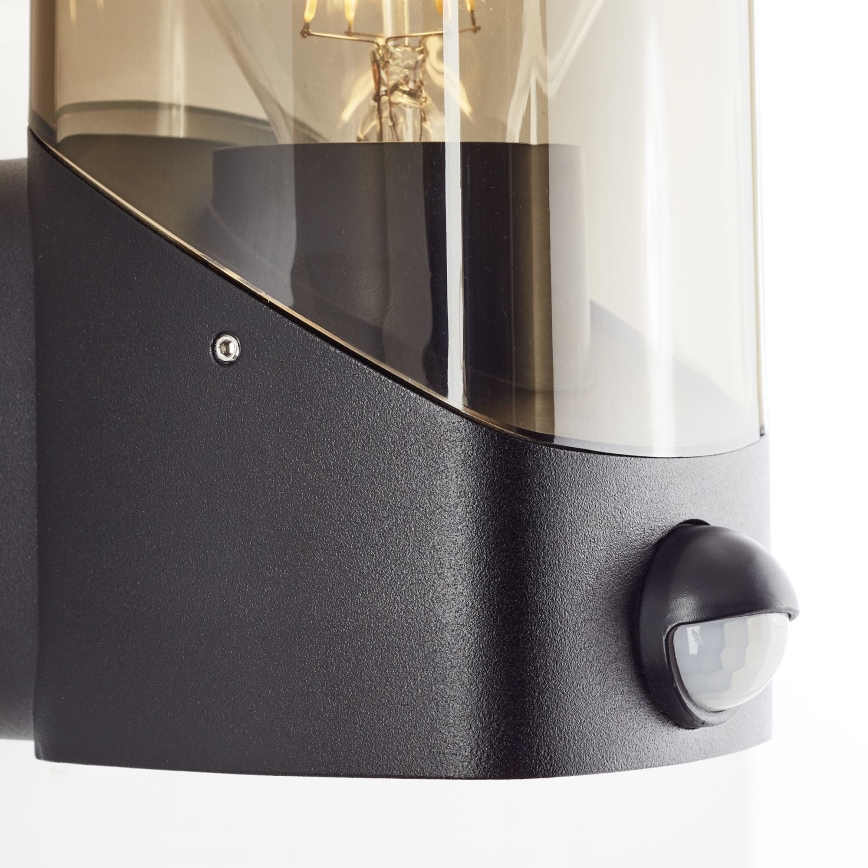Brilliant - Āra sienas lampa ar sensoru MINOU 1xE27/10W/230V IP44 melna/dūmakains