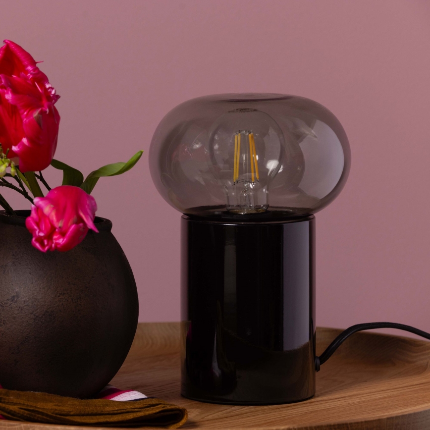Brilliant - Galda lampa KNUT 1xE27/25W/230V melna/caurspīdīga